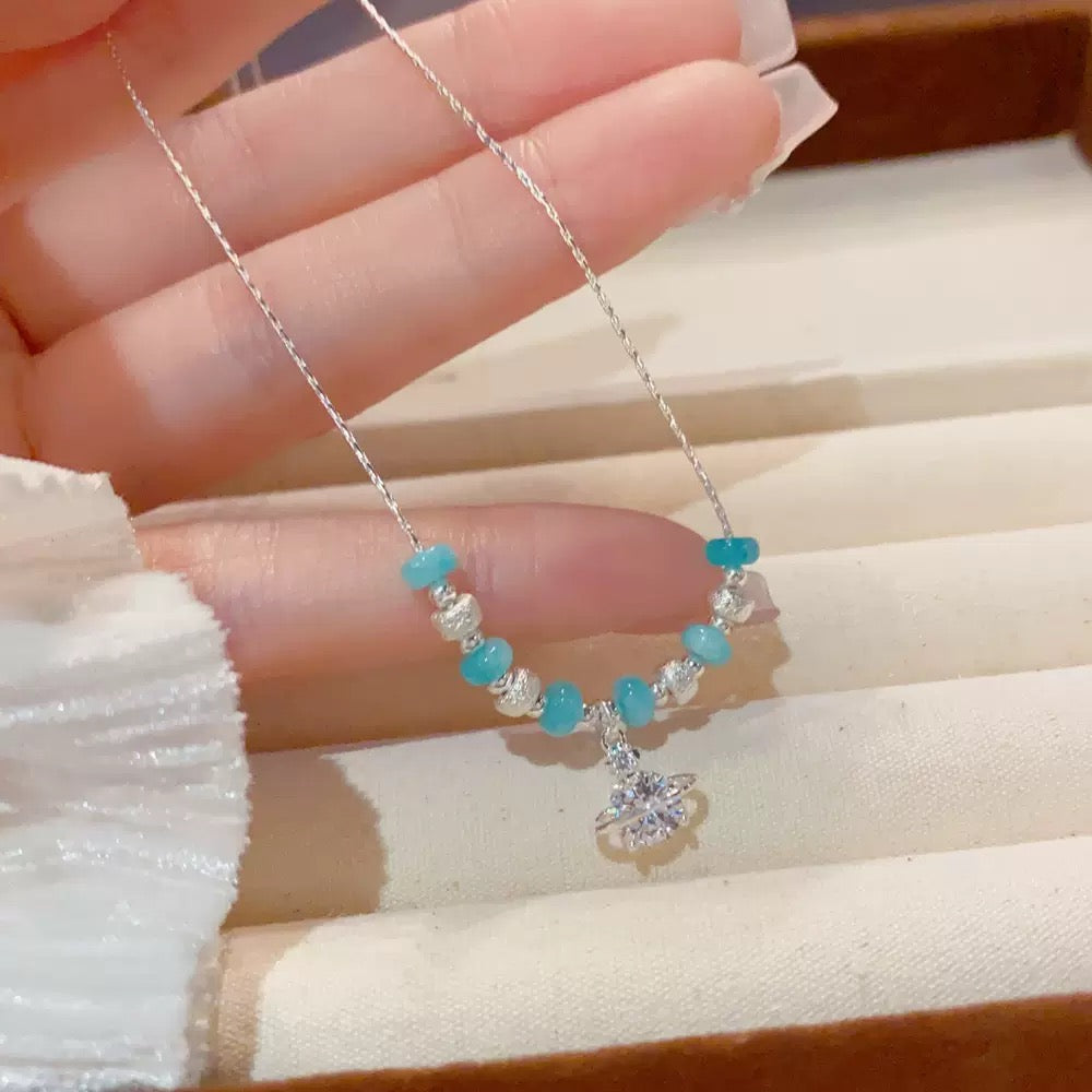 French-style versatile necklace featuring a Saturn pendant with chunky silver beads and cubic zirconia; a minimalist, chic, and understated luxury design—perfect as a clavicle chain.