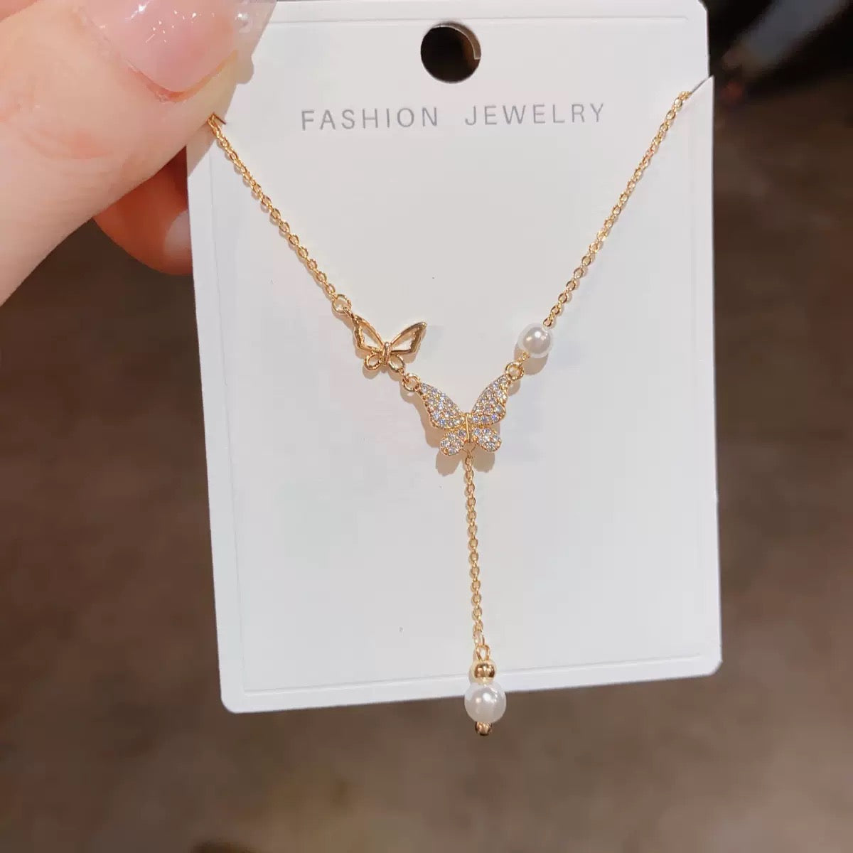 Niche-design, affordable luxury necklace featuring a micro-set cubic zirconia butterfly pendant and a pearl; an elegant clavicle chain/choker for women.